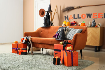 Wall Mural - Interior of festive living room with sofa, Halloween decorations and gift boxes