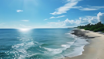 The vast coastline and blue sky, and the soft sunshine sprinkled on the beach, presenting a peaceful and beautiful natural scene.