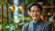 © 2D_Jungle - A man wearing glasses and a suit is smiling for the camera