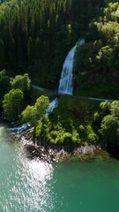 Wall Mural - Visit the stunning Fjaerlands Fjord Mundal waterfall in Norway, where water cascades into lush greenery, providing adventure and tranquility for all travelers for your next trip