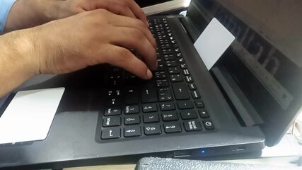 Close up of freelancer's developer hands typing program code on laptop keyboard in coworking