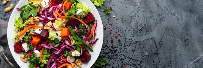 Wall Mural - Aerial perspective of a fresh spring salad featuring carrots, beets, cabbage, nuts, and herbs in a white bowl, showcasing an empty area for text.