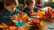 © Intania - Little Boy Making Paper Leaf Crafts at a Table