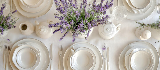 Elegant summer table setup with white dishes and lavender sprigs for a relaxing meal