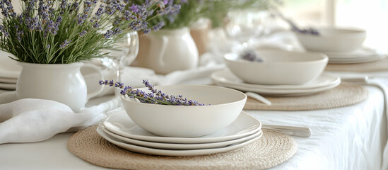 Elegant summer table setup with white dishes and lavender sprigs for a relaxing meal