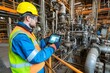 © senyumanmu - Industrial Worker Inspecting Machinery with Tablet
