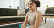 © PeakPoints/peopleimages.com - House, meditation and woman with yoga, calm and healthy girl with routine, training and spiritual in lounge. Apartment, yogi and person in living room, chakra and lotus for wellness, zen and fitness