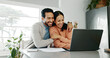 © peopleimages.com - Happy couple, paperwork and hug with laptop for budget, paying bills or estate planning. Married people, embrace and documents for insurance policy, investing and savings in apartment or family home