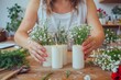 © Ryzhkov - White Adult Woman Crafting Flower-Shaped Candle Bouquet in Rustic Workshop, Late Afternoon, Concentrated and Anxious Mood, Surrounded by Vintage Tools and Materials