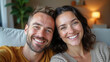 © cobaltstock - Happy couple smiling for a selfie at home