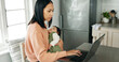 © PeakPoints/peopleimages.com - Mother, baby and laptop in kitchen for remote work, reading email and business report with spreadsheet. Woman, newborn and technology in house for freelance, video call and research as entrepreneur