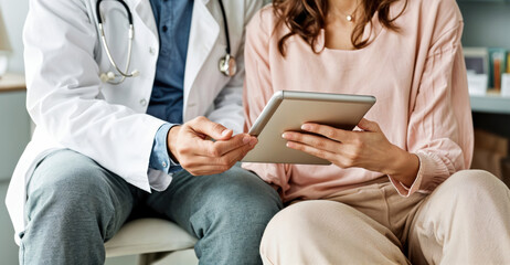 Doctor and patient discussing about a treatment using a digital tablet. High quality photo