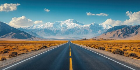 Asphalt Road Leading to Snowy Mountain Range