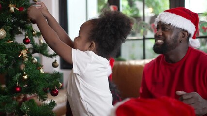 Wall Mural - Family decorate Christmas tree at home. Christmas and celebration.