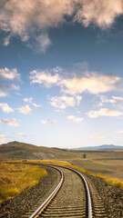 Vertical railway track with scenic sky, perfect for wallpaper or background use, symbolizing journeys