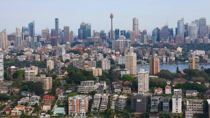 Poster - Aerial drone view of the suburb of Darling Point in East Sydney, NSW, Australia in September 2024 showing Sydney City large and prominent in the background with lens compression  