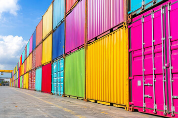 A vibrant display of shipping containers in various colors, stacked neatly at a port, showcasing industrial transport.