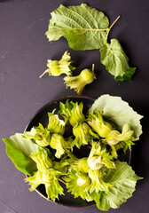 Poster - hazelnuts on black table