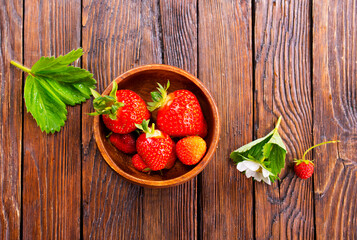 Wall Mural - Close up of ripe organic strawberry food wooden table