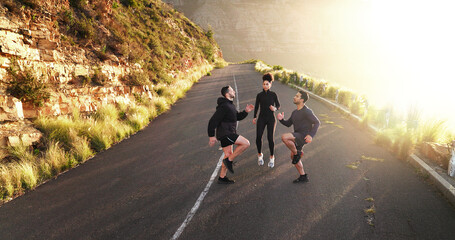 Wall Mural - Fitness, friends and warm up on road for exercise, training and running preparation. People, jog on the spot and cardio on mountain asphalt for wellness, coaching and muscle development in challenge