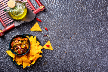 Canvas Print - Single big black plate of yellow corn tortilla nachos chips with salsa sauce