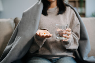 woman holding bottle with pills on hand going to take medicaments prescribed by his physician.