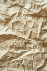 Poster - Crumpled beige paper texture background with folded edges. Close-up view of paper surface from above. Perfect for design and art projects. Use as a unique background or element in your composition.