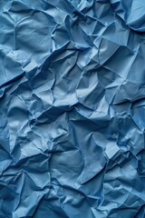 Poster - Crumpled blue fabric texture with shiny material. Close-up view of folded and creased surface. Prominent blue color stands out in this high-angle shot.