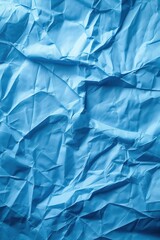 Poster - Crumpled blue paper texture background with creased surface. Close-up view of folded and wrinkled material on white background. Ideal for design projects, creative work, and artistic expressions.
