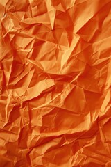 Poster - Crumpled orange paper texture background with unique perspective. Close-up view of folded and creased surface in blurred orange color. Perfect for design projects, creative arts, and digital media.