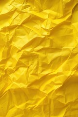Poster - Crumpled yellow paper texture with crease. Close-up view of rough surface on solid yellow background. Ideal for design, illustration and creative projects.