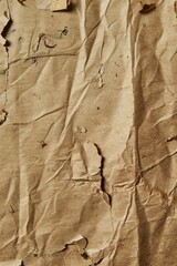 Leinwandbilder - Brown paper texture close-up. Crumpled recycled craft material with torn edges. Flexible surface reveals inner structure. Blurred background highlights paper natural texture and details.