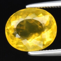 Wall Mural - Captivating Close-Up of a Radiant Yellow Sapphire Gemstone Held by Precision Tweezers on a Dark Background