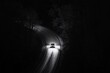 © Stanley - A car navigating a winding road illuminated by headlights on a dark night surrounded by trees