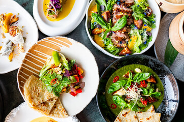 Assorted gourmet dishes on a table, showcasing culinary variety and vibrant colors. Perfect for food-related content, restaurant promotions, or culinary blogs.