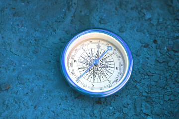 classic navigation compass on natural background