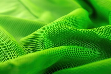 Aufkleber - Close-up of green fabric with small circular holes, textured surface, synthetic material possibly polyester. Fabric appears durable, water-resistant. Blurred background highlights intricate details.
