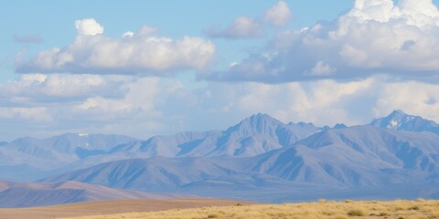 Canvas Print - Mountain range under a blue sky with fluffy clouds.