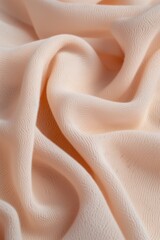 Aufkleber - Close-up view of fabric with light pink hue, folded in half to reveal intricate texture and pattern. Fabric appears smooth with subtle folds, background blurred to focus on details.