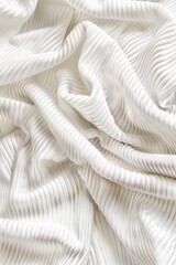 Aufkleber - Close-up view of white fabric with crinkled texture folded in half showing intricate pattern and creases. Fabric stands out against solid gray background drawing attention to its unique design.