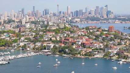 Wall Mural - Aerial drone view of the suburb of Point Piper in East Sydney, NSW, Australia in September 2024 showing Sydney City large and prominent in the background with lens compression techniques 