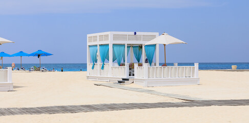 Wall Mural - seaside resort beach with white sand and a gazebo for relaxation