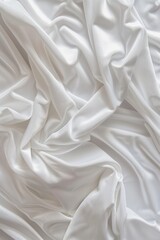 Aufkleber - Close-up view of white fabric with intricate texture folds. Fabric appears smooth and soft, possibly made of velvet or cotton. The background is blurred to focus on the fabric details.
