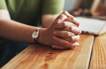 Wall Mural - Woman, hands and praying on desk for worship, jesus christ and christian praise for salvation in home. Female person, spiritual healing and thank you to God, practice religion and grace for peace