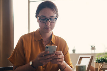 Aufkleber - Woman, cellphone and scroll with thinking for writing, blog or article in home office. Journalist, website and smartphone for remote work, planning or copywriter research for house freelance career