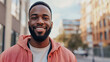 © Michael - Young black man confidently strolls through a busy city street on a sunny day, exuding happiness and authenticity with his stylish look and genuine smile