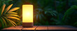 © enterdigital - A glowing lamp on a wooden table surrounded by lush green foliage, creating a serene and inviting atmosphere.