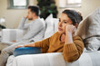 © Chanelle2000/peopleimages.com - Unhappy couple, argument and fight with living room, angry and drama in disagreement as partner. Woman, man and annoyed with frustrated, depressed and differences in home or lounge as married people
