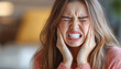© ЮРИЙ ПОЗДНИКОВ - Young woman experiencing severe toothache at home