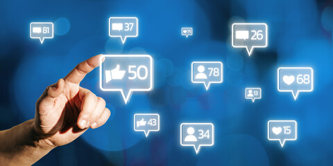 Poster - Hand interacting with glowing social media icons on blue background.